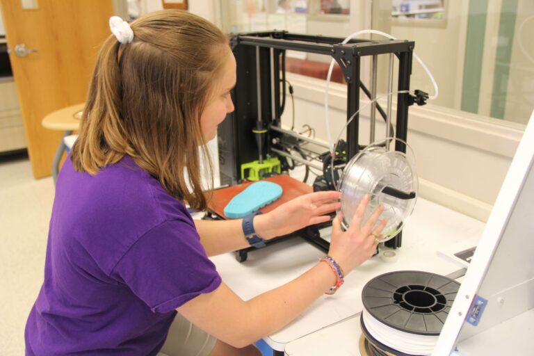 Student sitting at a science lab.